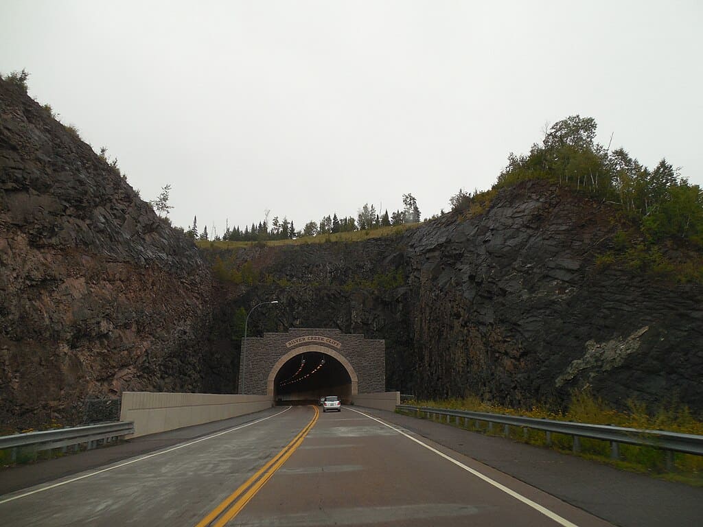 A view from a vehicle driving north about to enter the Silver Creek Cliff Tunnel.