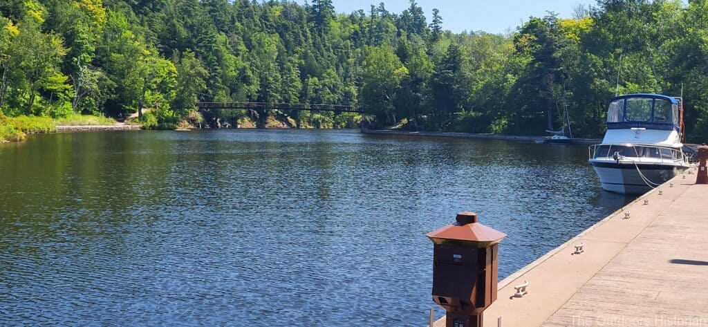 A view of the river looking north and a boat docked that is used for charter fishing tours.